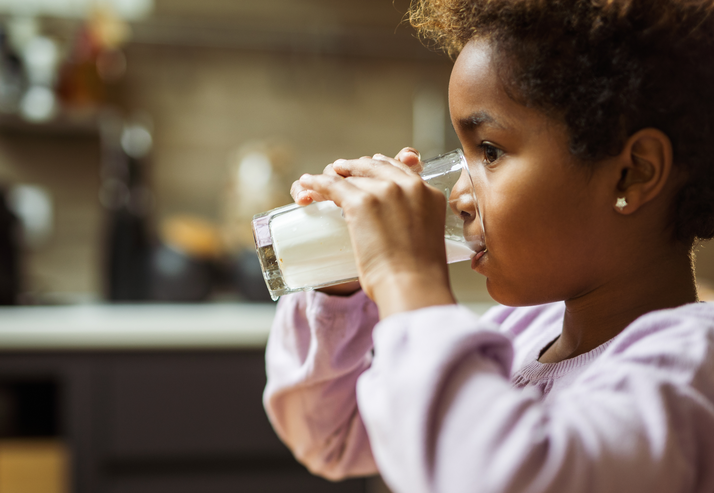Child drinking a glass of milk
